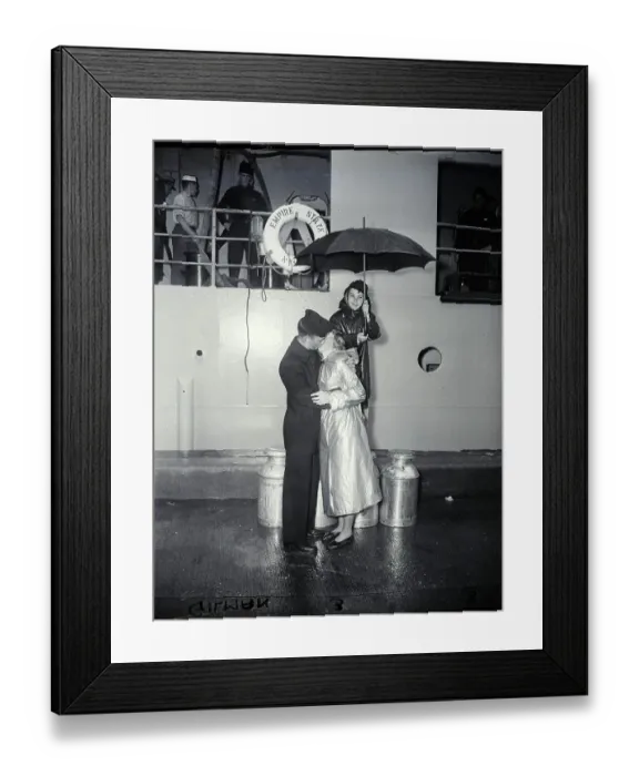Framed Print : Couple Kiss Goodbye As Boy Holds Umbrell