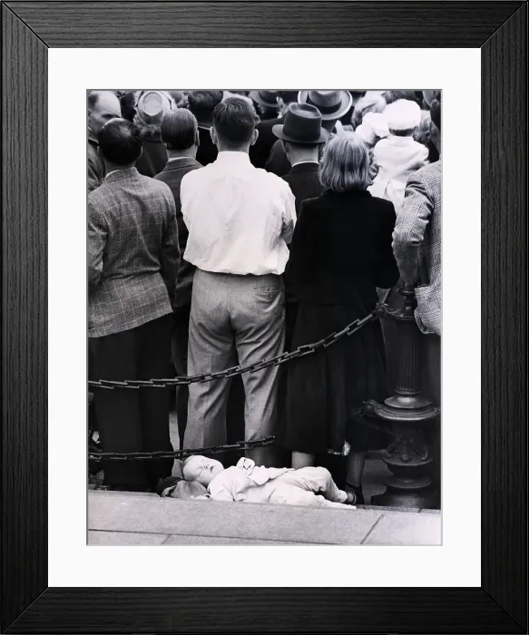 Framed Print : Child Sleeping Behind People Watching Pa