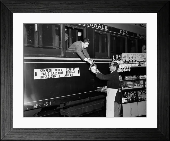 Framed Print : Railside Vendors Meet Train At Station