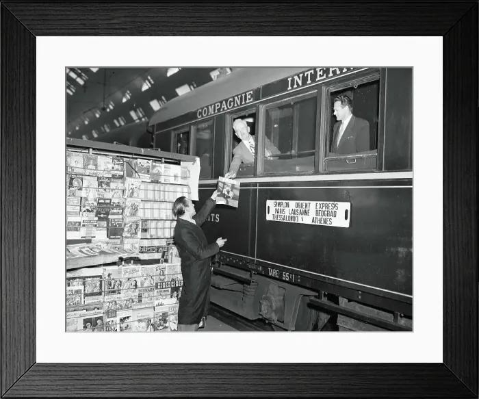 Framed Print : News Vendor Handing Magazine to Simplon-Orient Express Passenger Framed Print : News Vendor Handing Magazine to Simplon-Orient Express Passenger