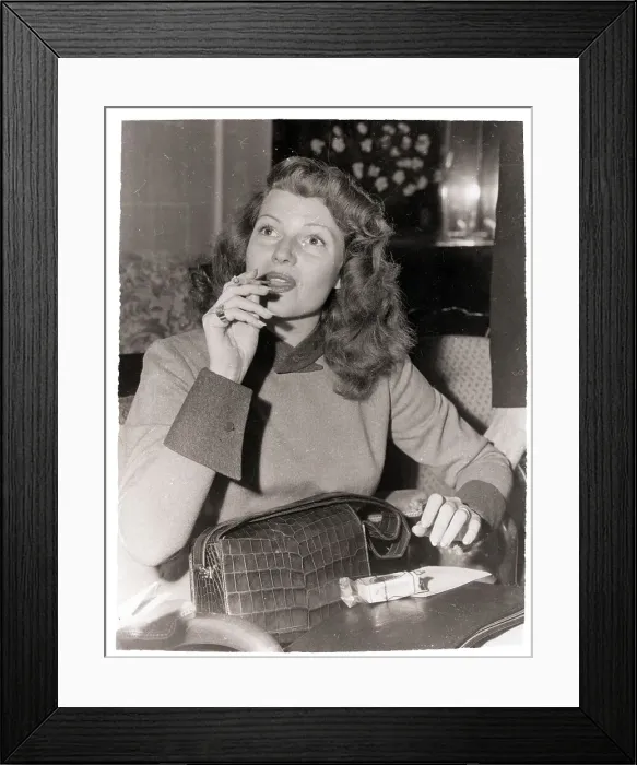 Framed Print : Rita Hayworth Smoking a Cigarette Framed Print : Rita Hayworth Smoking a Cigarette