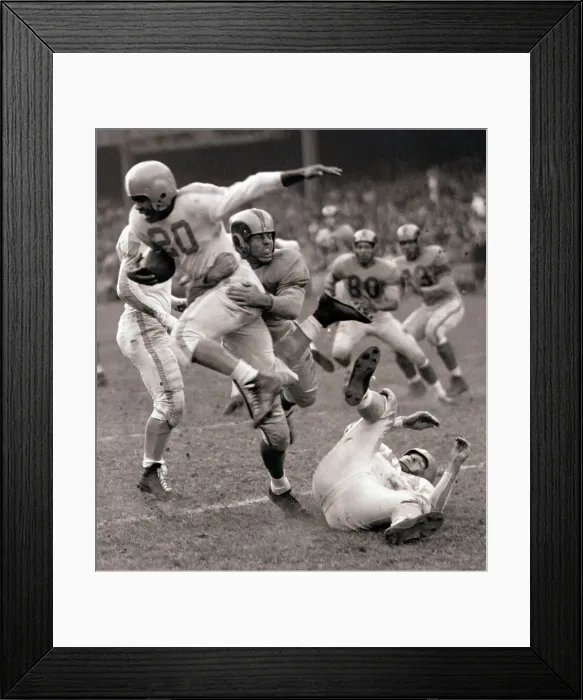 Framed Print : Football Player Leaping Through Air Framed Print : Football Player Leaping Through Air