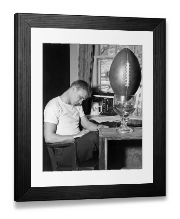 Framed Print : Football Player Working at Desk Framed Print : Football Player Working at Desk