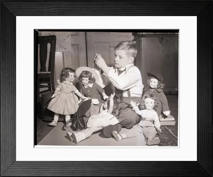 Framed Print : Boy Playing with Designer Dressed Dolls Framed Print : Boy Playing with Designer Dressed Dolls