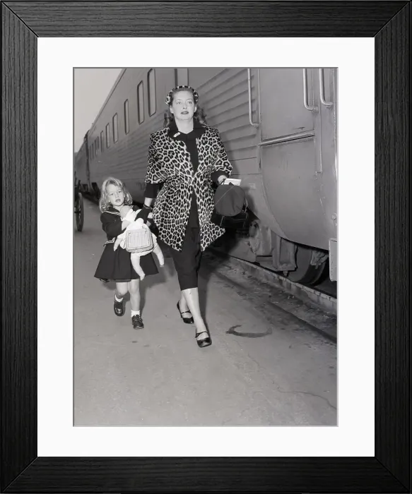 Framed Print : Bette Davis Walks with Daughter at Train Station Framed Print : Bette Davis Walks with Daughter at Train Station