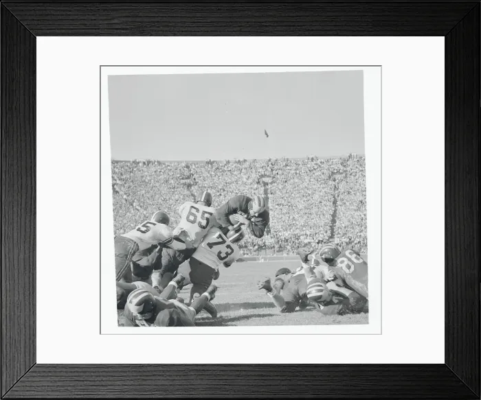 Framed Print : Football Players Tackling Their Opponent Framed Print : Football Players Tackling Their Opponent