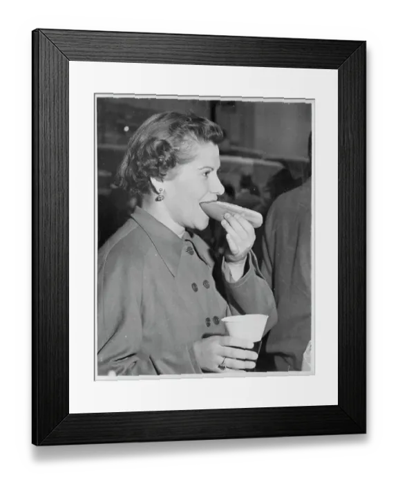 Framed Print : Young New York City Woman Eating a Hot Dog with Drink in Hand Framed Print : Young New York City Woman Eating a Hot Dog with Drink in Hand