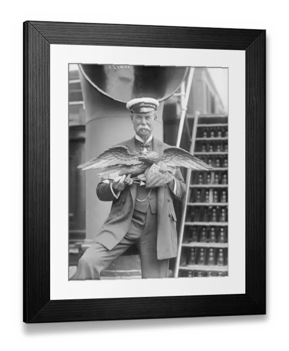 Framed Print : Man Holding Wooden Eagle from America Yacht Framed Print : Man Holding Wooden Eagle from America Yacht