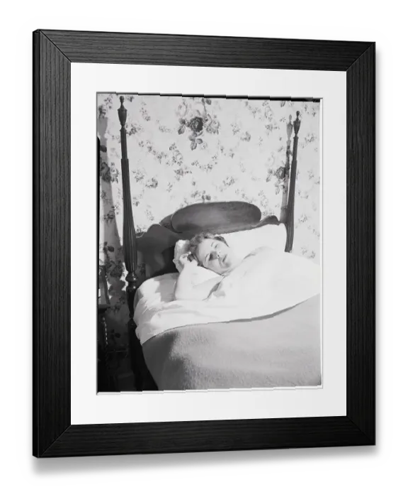 Framed Print : Young Woman Lying in Bed Framed Print : Young Woman Lying in Bed