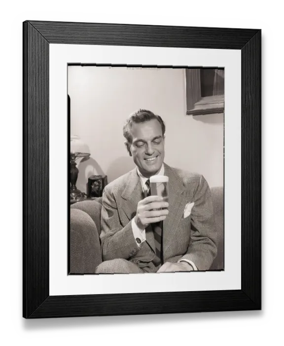 Framed Print : Man Sitting on Couch with Glass of Beer
