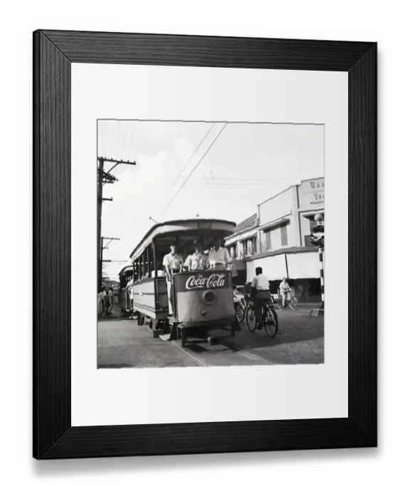Framed Print : Cyclists Peddle By Trolleys Framed Print : Cyclists Peddle By Trolleys