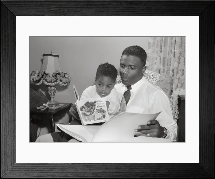 Framed Print : Jackie Robinson Reading Alongside His Young Son Framed Print : Jackie Robinson Reading Alongside His Young Son