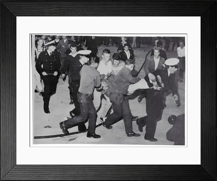 Framed Print : Police Carrying a Resisting Rock and Roll Fan Framed Print : Police Carrying a Resisting Rock and Roll Fan