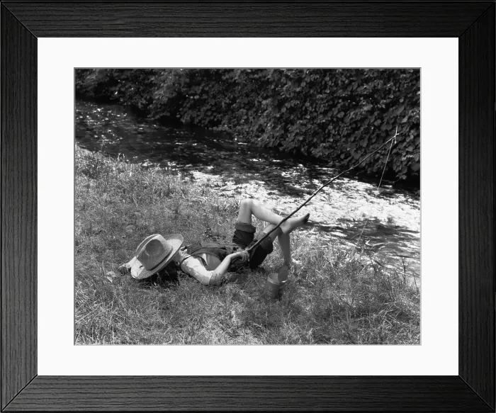 Framed Print : Boy Fishing with Hat Over Face Framed Print : Boy Fishing with Hat Over Face
