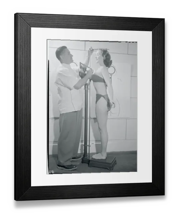 Framed Print : Doctor Measuring Woman's Height Framed Print : Doctor Measuring Woman's Height