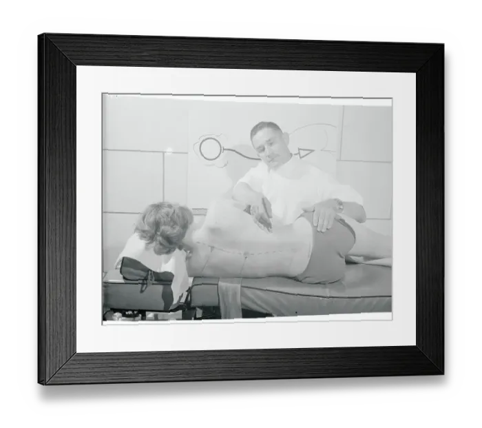 Framed Print : Doctor Writing on Woman's Back Framed Print : Doctor Writing on Woman's Back