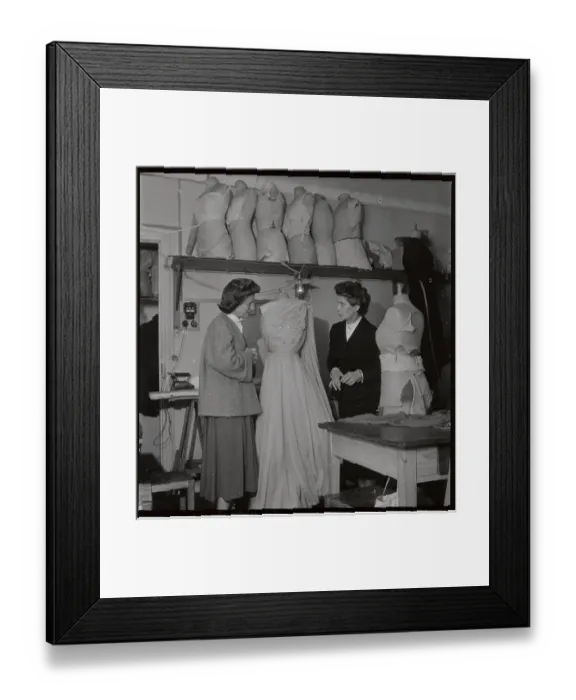 Framed Print : Fashion Designer and Assistant Discussing Dress Framed Print : Fashion Designer and Assistant Discussing Dress