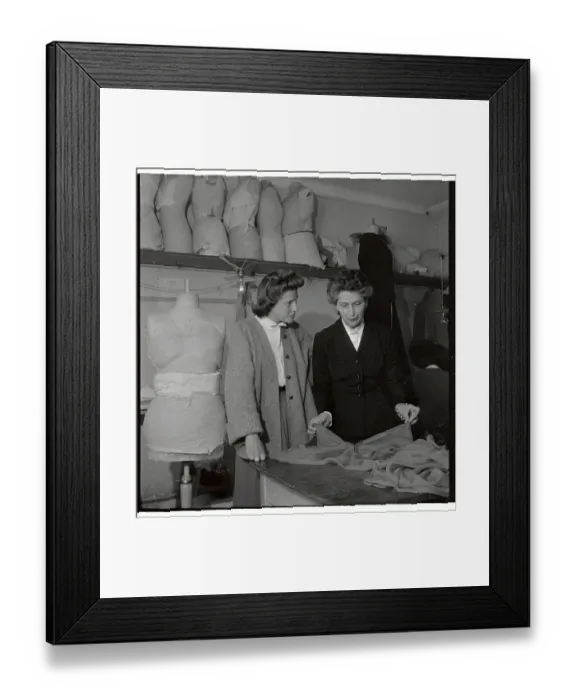 Framed Print : Mad Carpentier and Assistant Discussing Fabric Framed Print : Mad Carpentier and Assistant Discussing Fabric