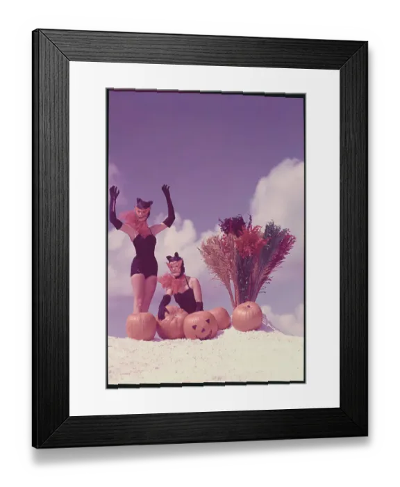 Framed Print : Young Women in Costume Posing on Beach with Pumpkins