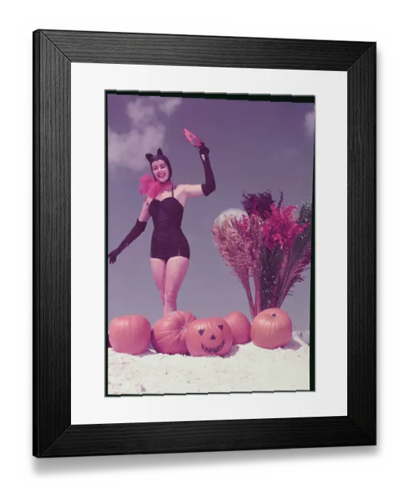 Framed Print : Young Woman in Costume Posing on Beach with Pumpkins Framed Print : Young Woman in Costume Posing on Beach with Pumpkins