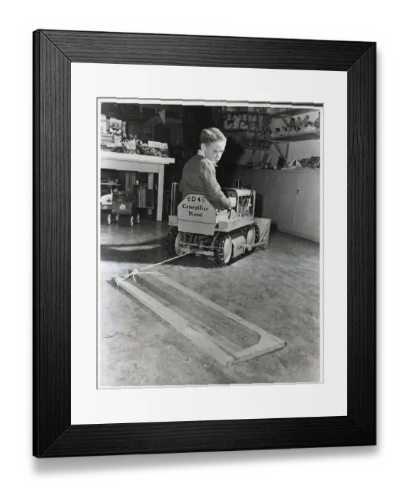 Framed Print : Boy Driving Toy Bulldozer