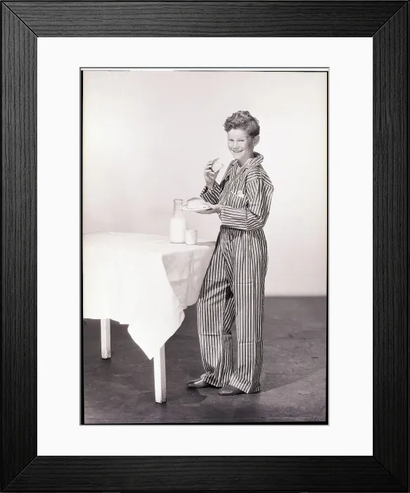 Framed Print : Boy in Pajamas Eating Cake and Milk Framed Print : Boy in Pajamas Eating Cake and Milk