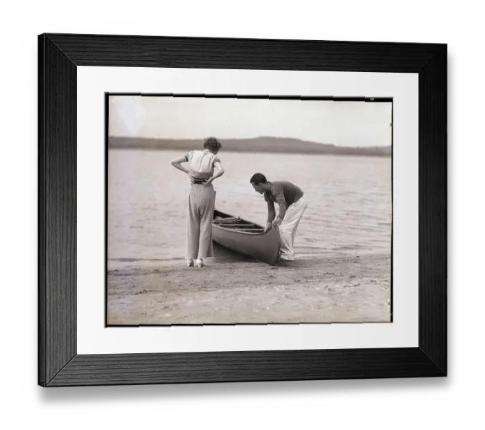 Framed Print : Couple Launching a Canoe Framed Print : Couple Launching a Canoe