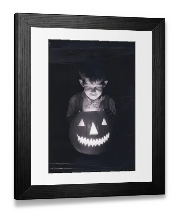 Framed Print : Boy Looking into Jack O'Lantern Framed Print : Boy Looking into Jack O'Lantern