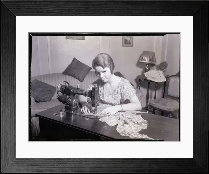 Framed Print : Woman Using a Sewing Machine Framed Print : Woman Using a Sewing Machine