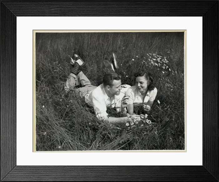 Framed Print : Young Couple Lying on Grass Framed Print : Young Couple Lying on Grass
