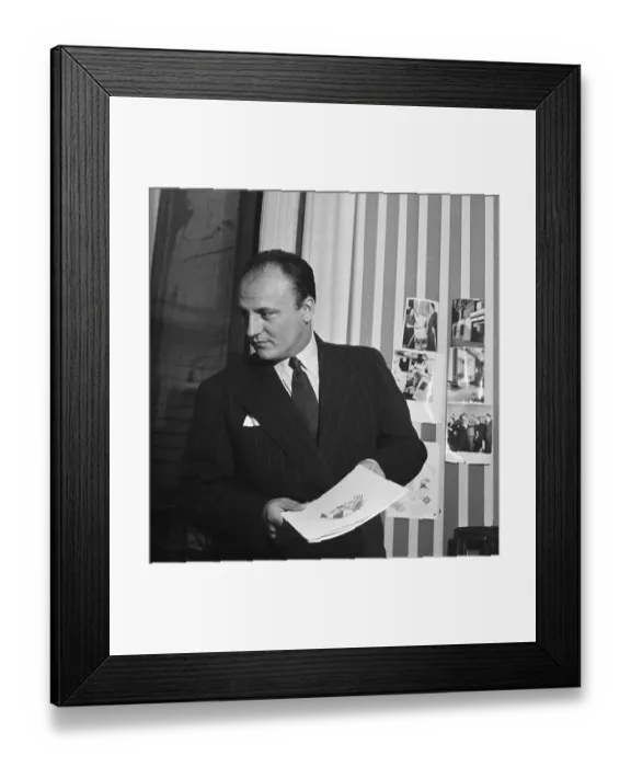 Framed Print : Designer Pierre Balmain Holding Book Framed Print : Designer Pierre Balmain Holding Book