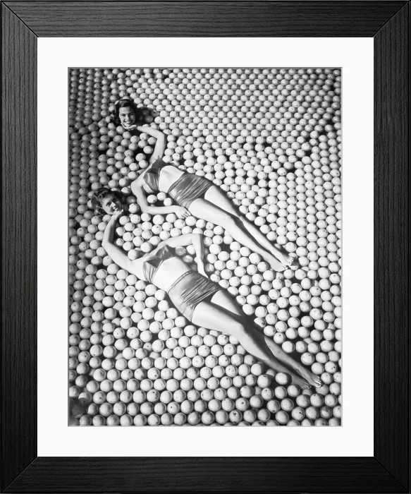 Framed Print : Women in Pool of Oranges Appear Headless Framed Print : Women in Pool of Oranges Appear Headless
