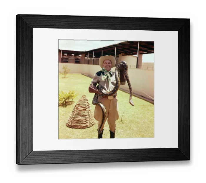 Framed Print : Lawrence Hautz Holding a Snake Framed Print : Lawrence Hautz Holding a Snake
