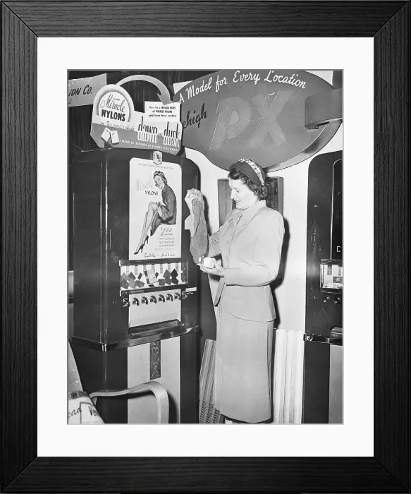 Framed Print : Woman Getting Stockings From Machine Framed Print : Woman Getting Stockings From Machine