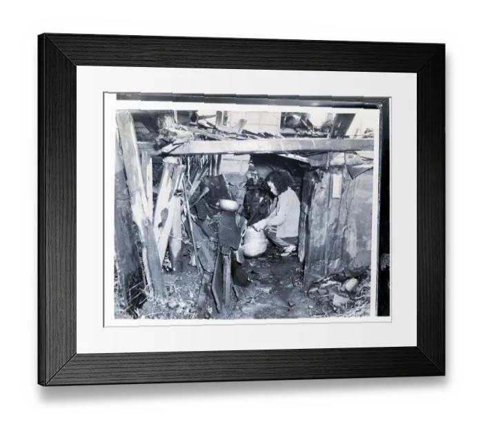 Framed Print : Woman Kneels In Her Ramshackle Shelter Framed Print : Woman Kneels In Her Ramshackle Shelter