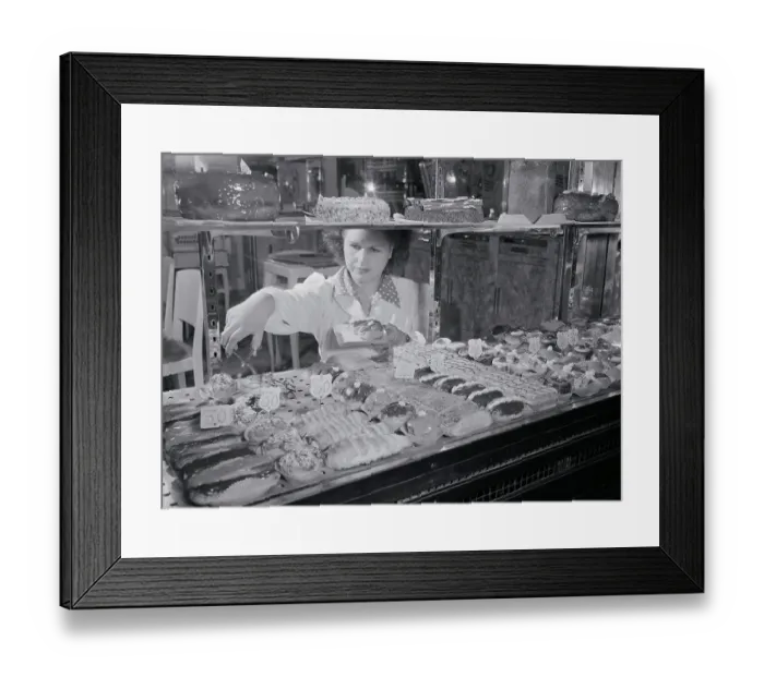Framed Print : Woman Selecting French Pastries from Display Framed Print : Woman Selecting French Pastries from Display