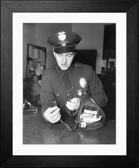 Framed Print : Police Officer Examining Missing Woman's Purse Framed Print : Police Officer Examining Missing Woman's Purse