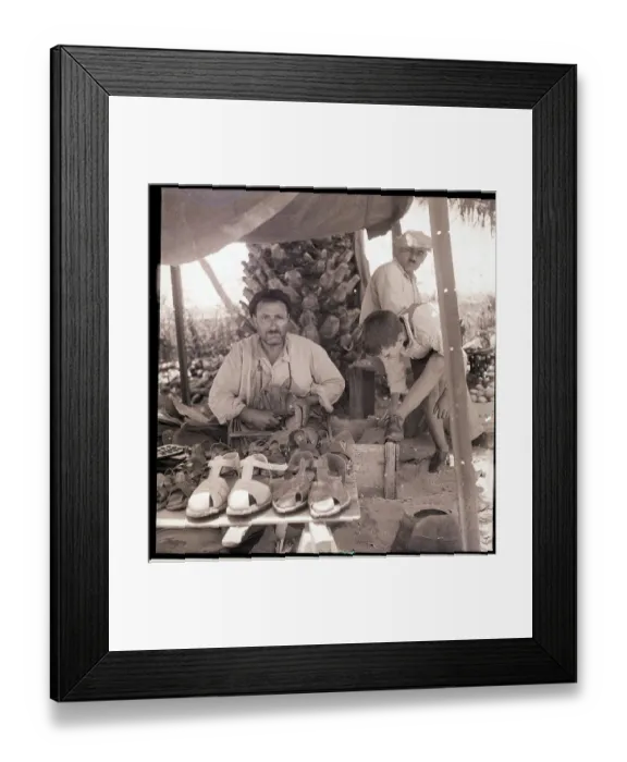 Framed Print : Shoemaker Working in Outdoor Shop