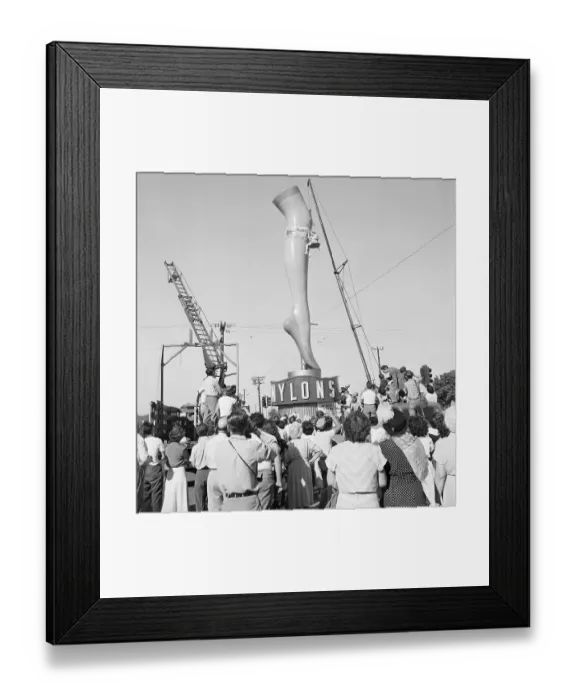 Framed Print : Woman Hoisted Next to a Giant Plaster Leg Framed Print : Woman Hoisted Next to a Giant Plaster Leg
