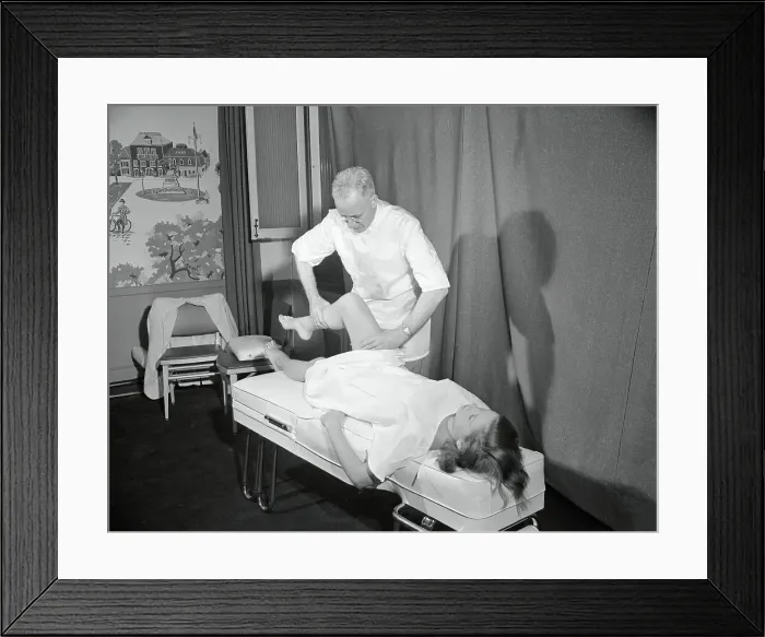 Framed Print : Dr. Exercising Woman's Leg Framed Print : Dr. Exercising Woman's Leg