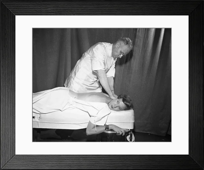 Framed Print : Doctor Massaging Women's Back Framed Print : Doctor Massaging Women's Back