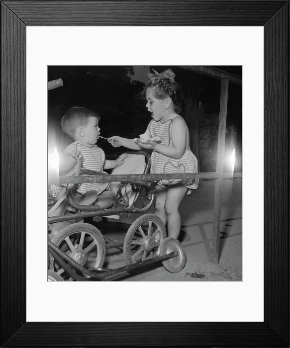 Framed Print : Little Girl Feeding Ice Cream To Younger Brother Framed Print : Little Girl Feeding Ice Cream To Younger Brother