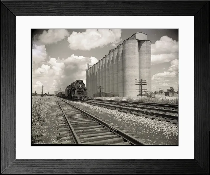 Framed Print : Freight Train Passing Grain Elevators Framed Print : Freight Train Passing Grain Elevators