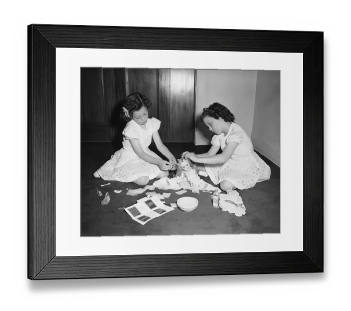 Framed Print : Twins (6-7) playing with doll, Chicago, Illinois, USA Framed Print : Twins (6-7) playing with doll, Chicago, Illinois, USA