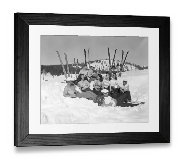 Framed Print : Group of Sunbathing Skiers