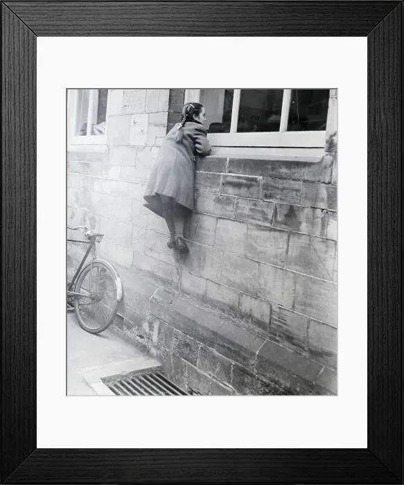 Framed Print : Girl Looks Into Window Of Building Framed Print : Girl Looks Into Window Of Building