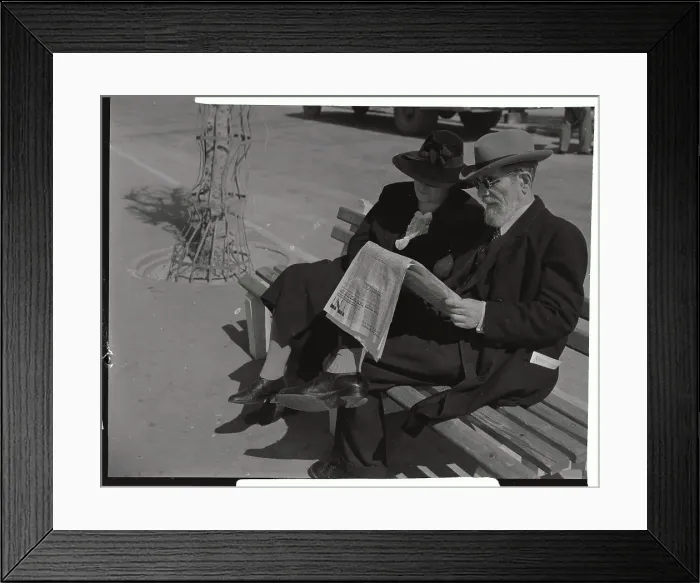 Framed Print : Couple Reading Newspaper Together on Bench Framed Print : Couple Reading Newspaper Together on Bench