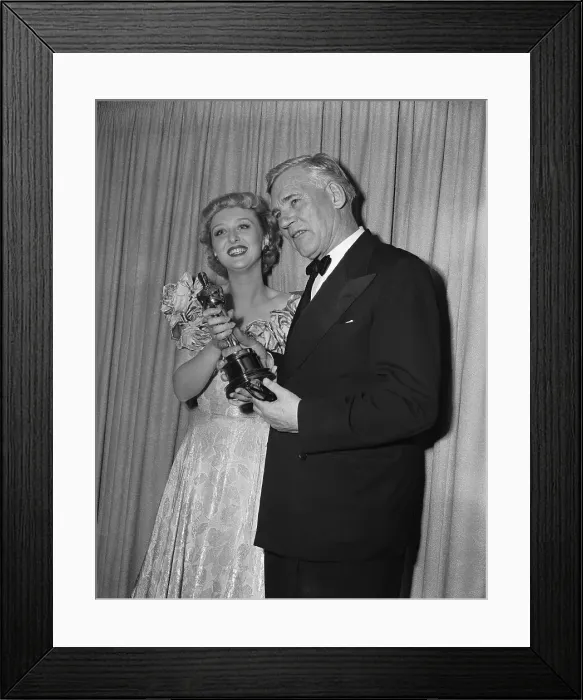 Framed Print : Celeste Holm and Walter Huston Holding Oscar Framed Print : Celeste Holm and Walter Huston Holding Oscar