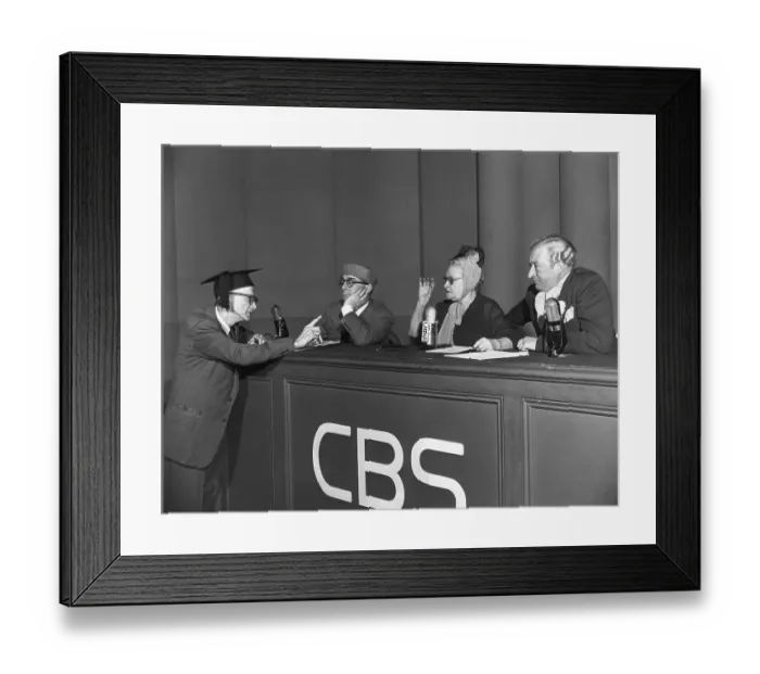 Framed Print : Man Pointing To Woman On Panel Framed Print : Man Pointing To Woman On Panel