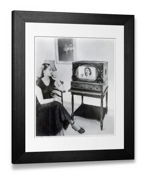 Framed Print : Woman Sits And Watches Television In Ad Framed Print : Woman Sits And Watches Television In Ad